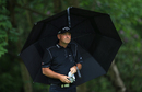 Thomas Bjorn shelters under an umbrella