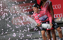 Rigoberto Uran celebrates claiming the race leader's pink jersey on the podium of the 12th stage individual time trial