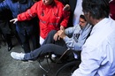 Luis Suarez leaves a clinic in a wheelchair