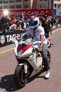 Lewis Hamilton drives a motorbike in the pitlane