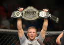T.J. Dillashaw celebrates after defeating Renan Barao in their bantamweight championship bout