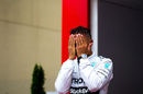 Lewis Hamilton reacts on the podium after finishing second