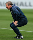 England manager Roy Hodgson squats during training
