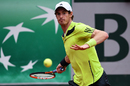 Andy Murray returns a shot to Andrey Golubev