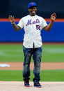 Rapper 50 Cent looks embarrassed after throwing the ceremonial first pitch