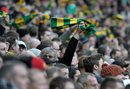 A Manchester United fan waves a green and yellow scarf in protest over the ownership of the club by Malcolm Glazer