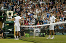 Novak Djokovic and Jo-Wilfried Tsonga await the outcome of match point