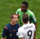Referee Mark  Geiger warns Olivier Giroud