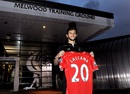 Adam Lallana poses with his new Liverpool shirt