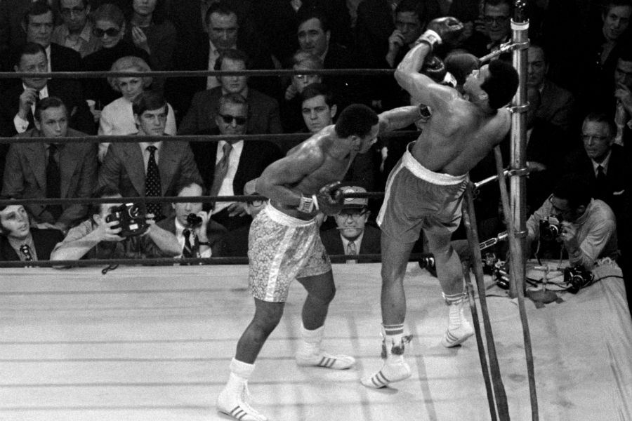 Joe Frazier catches Muhammad Ali with a left