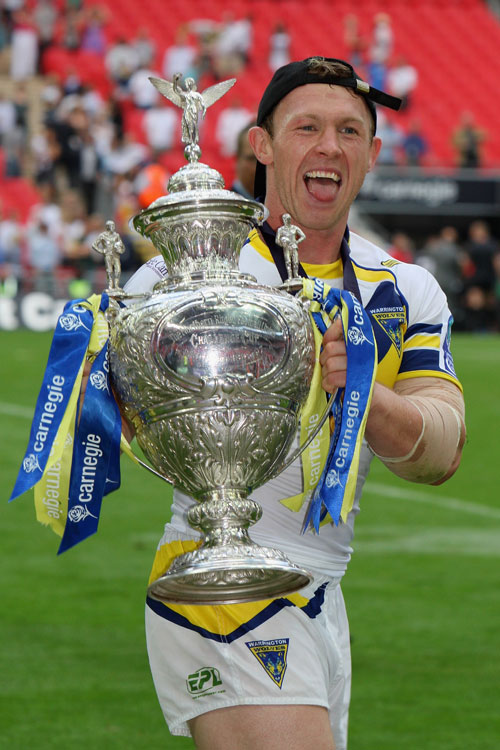 Mick Higham of Warrington celebrates with the trophy 