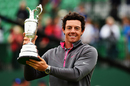 Rory McIlroy celebrates with the Claret Jug on the 18th green