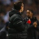 Gary Neville aims a gesture in the direction of Carlos Tevez
