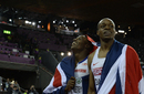 Harry Aikines-Aryeetey and James Dasaolu drape themselves in Great Britain's flag after Dasaolu won the 100m