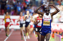 Mo Farah breaks out the 'Mo-bot' as he crosses the finish line to win the 5,000m final