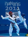 Eric Melki (right) competes with Dzime Davy Endamne in the taekwondo men's -55kg
