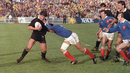 Sean Fitzpatrick tries to fend off French fullback Serge Blanco