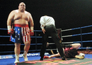 Eric 'Butterbean' Esch walks away while the referee counts out Britain's Shane Woollas during the first round of their super-heavyweight fight