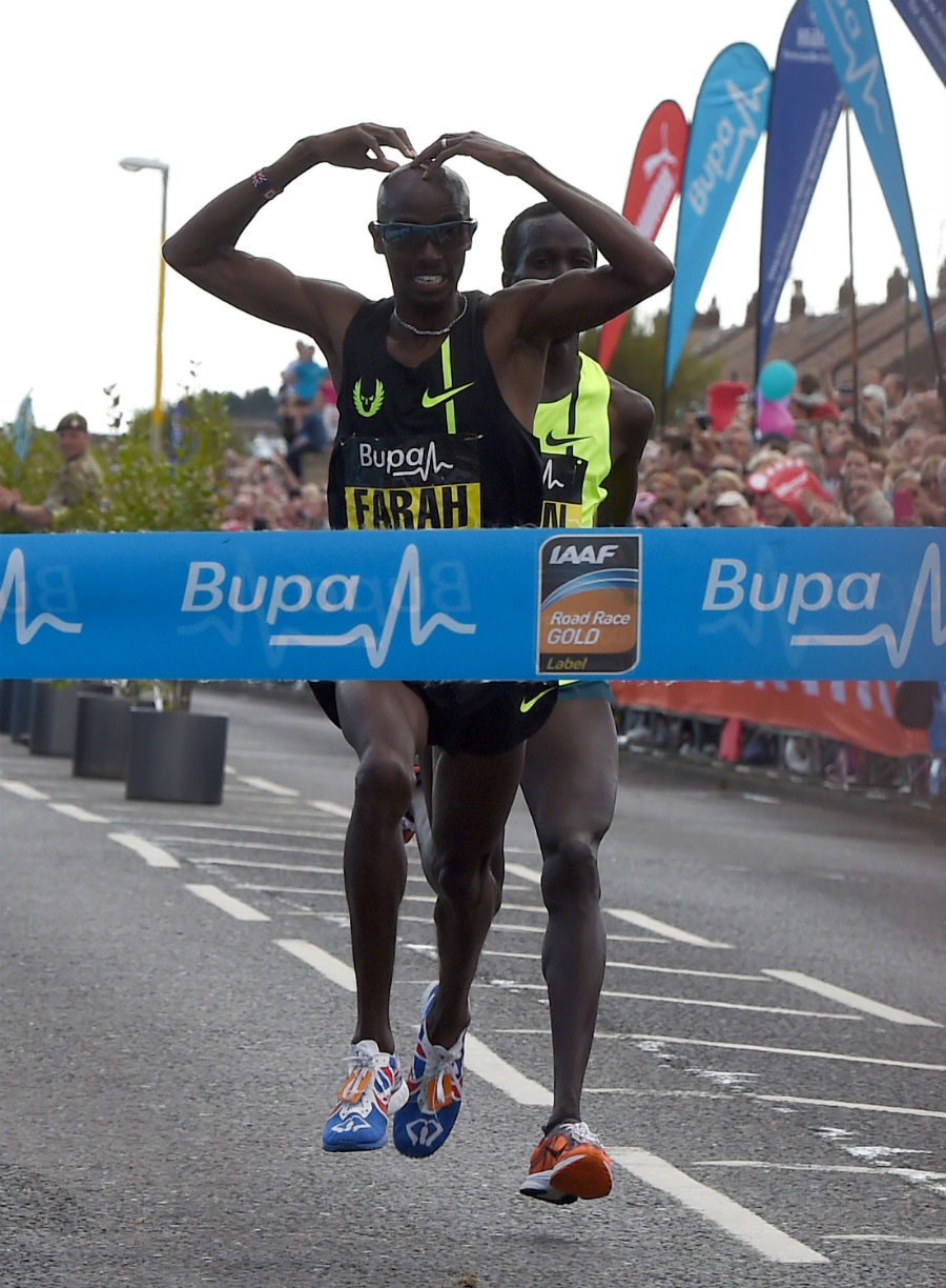 Mo Farah does the 'Mo-Bot' as he crosses the line at the Great North Run