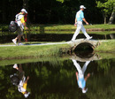 Paul Casey of England crosses the 8th bridge with his caddie Craig Connolly 