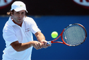 Fabrice Santoro plays a backhand in his first round match against Marin Cilic