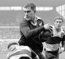 New Zealand's Colin Meads takes the ball into contact