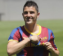 Barcelona's new signing David Villa smiles as he shows his new jersey 