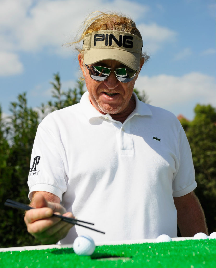 Miguel Angel Jimenez takes part in the traditional chopstick challenge ahead of the BMW Masters