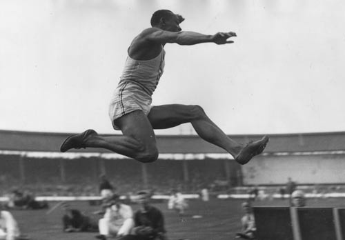 Jesse Owens competes in the long jump