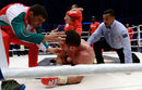 Kubrat Pulev is checked on by his team and the referee as Wladimir Klitschko celebrates