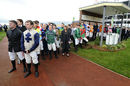 Jockeys line up to observe a minute's silence for Dessie Hughes