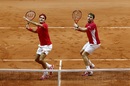 Roger Federer and Stanislas Wawrinka eye up the same volley in the Davis Cup