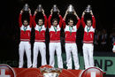 The Switzerland side is covered in red and white tape as they lift the Davis Cup