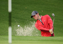 Rory McIlroy plays out of a bunker as he prepares for the Australian Open