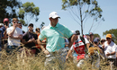 Rory McIlroy looks on from the rough on the ninth hole