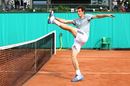 Andy Murray kicks a tennis ball
