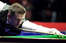 Mark Selby plays a shot against Oliver Brown