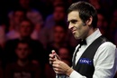 Ronnie O'Sullivan chalks his cue during his match with Peter Lines