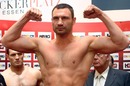 Vitali Klitschko flexes his muscles at the weigh-in