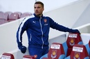 Lukas Podolski takes his seat on the bench
