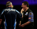 Phil Taylor shares a joke with Gary Anderson on stage
