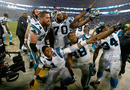 Cam Newton and his team-mates celebrate a 27-16 victory against the Arizona Cardinals after their NFC Wild Card play-off game