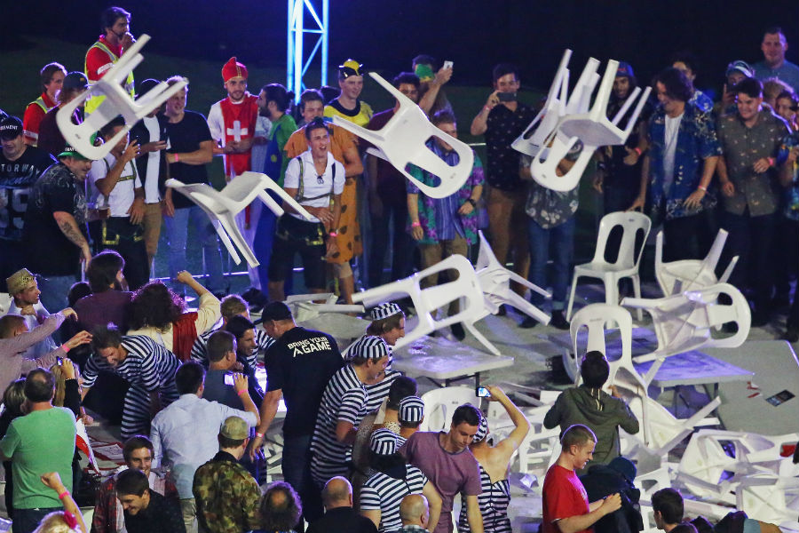 Spectators throw chairs as chaos breaks out