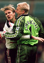 Peter Schmeichel is mobbed by David Beckham after saving a penalty from Dennis Bergkamp