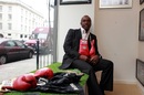 Nigel Benn poses with his gloves before an auction