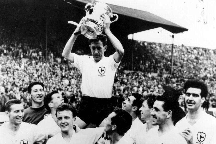 Tottenham Hotspur captain Danny Blanchflower holds the FA Cup trophy aloft 