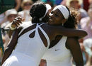 Serena and Venus Williams hug following their Wimbledon final