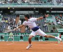 Novak Djokovic is forced to stretch to reach the ball