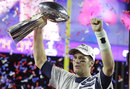 New England Patriots quarterback Tom Brady holds up Vince Lombardi Trophy