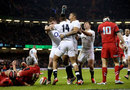 Anthony Watson is mobbed by team-mates after his first try for England
